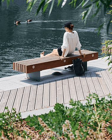 Women sitting water side bench at Canary Wharf